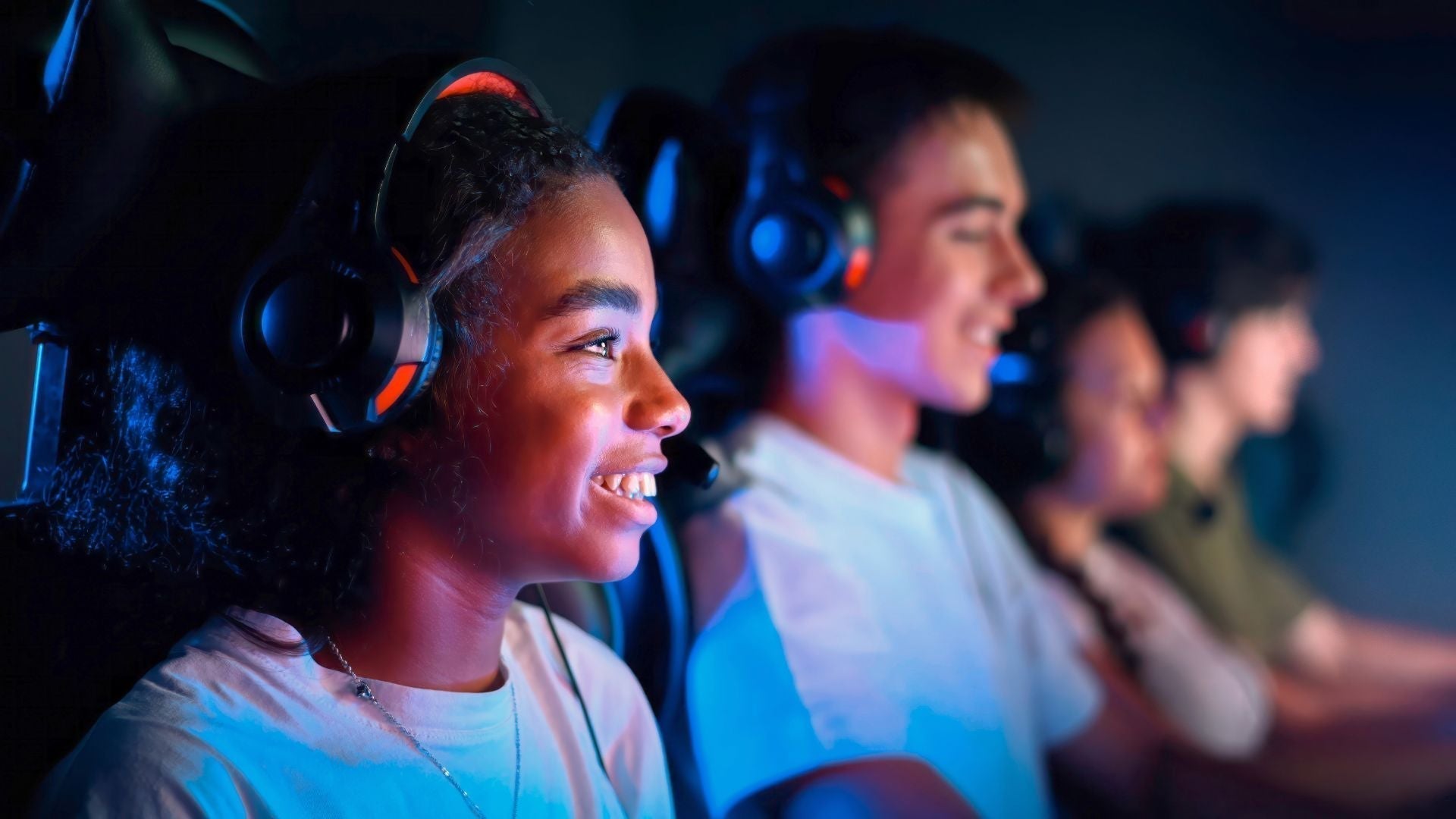 Girl playing video games with her esport team in a local club